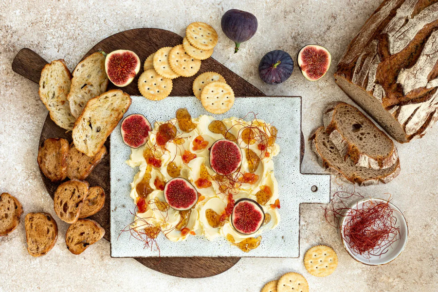 Jam Butter board with slices of bread, crackers, and figs