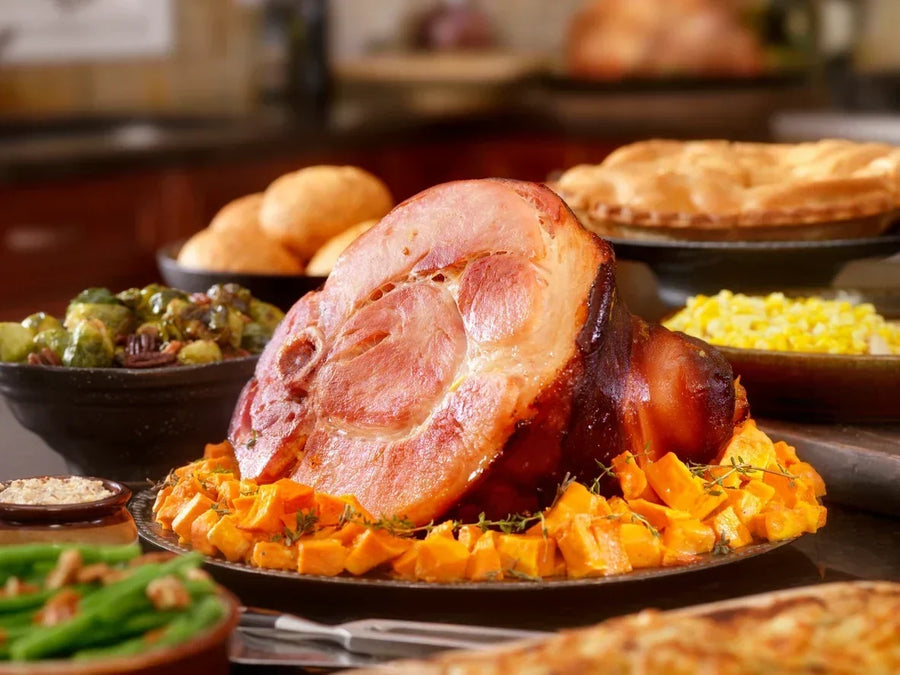 Holiday ham glazed with Mrs. Ruth's Winterberry Jam, caramelized to a deep glossy finish on a roasting rack