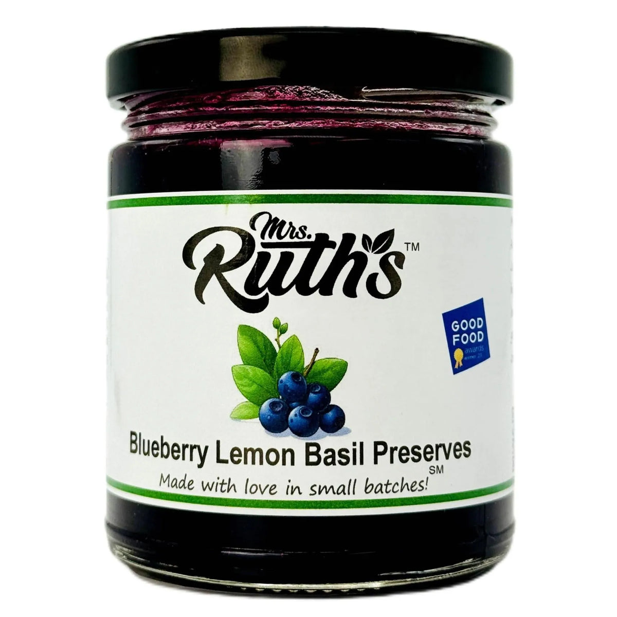 A glass jar of Mrs. Ruth's Blueberry Lemon Basil Preserves with a black lid and a white label featuring blueberries and green leaves, set against a plain white background.